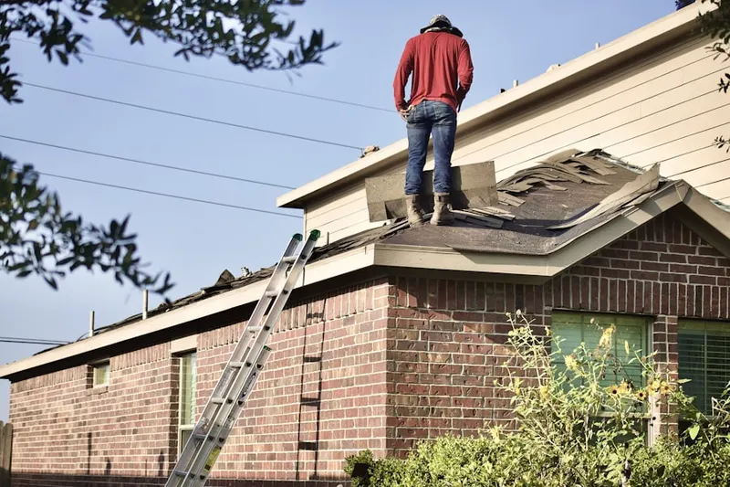 Professional roofer working on a residential roof in Dearborn Heights
